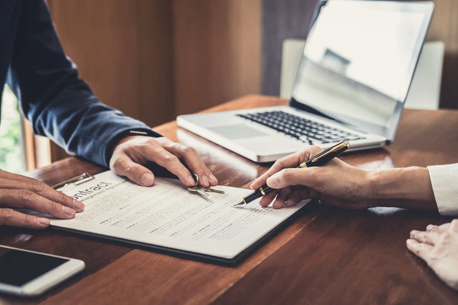 Sales Manager Filing Keys to Customer after Signing Rental Lease